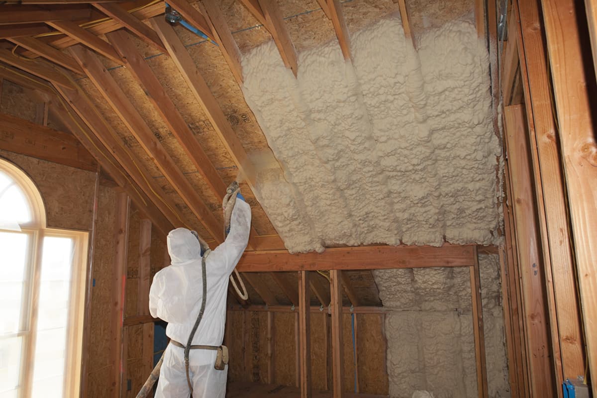 Spray foam insulation being applied in an attic